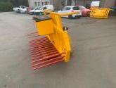 Hydraulic tipping stone fork with tool/weight box